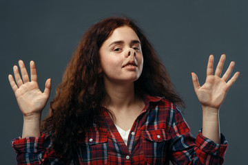 Woman's funny face crushed on transparent glass