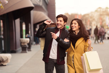Shopping together. Couple looking at fashion store's window