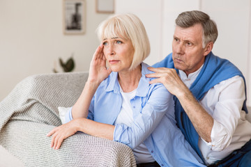 Mature couple arguing, man trying to resolve family conflict