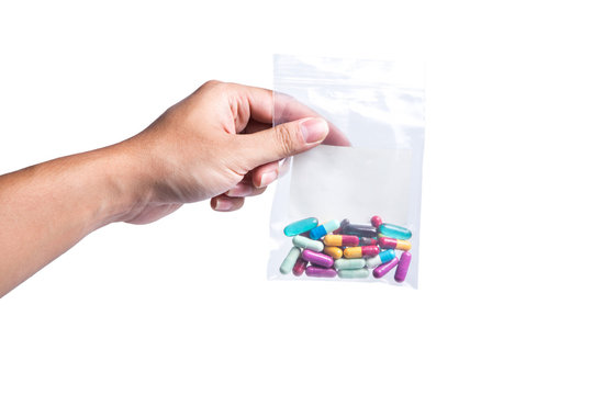 man holding pills on hand medicine health care concept on white background