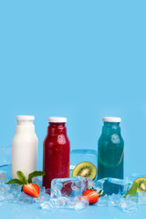 Healthy detox drinks of fresh ingredients on blue background