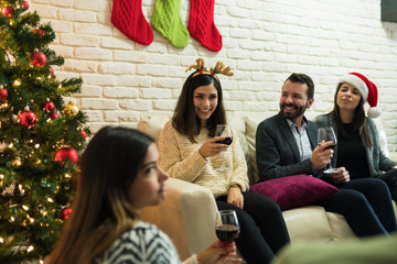 Mid Adult Pals Enjoying Christmas Party At Home