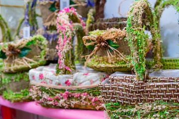 Fototapeta na wymiar Decorative baskets decorated with flowers. Natural background.
