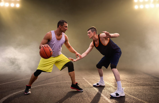 Two basketball players playing the game on court
