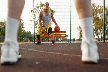 Male basketball player with ball shows his skill