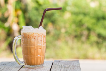 Thai iced tea signature local beverage on wooden background Cha Yen Called in thai