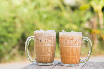 Thai iced tea and iced coffee signature local beverage on wooden background