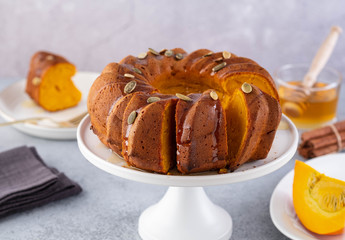 Pumpkin cake with honey on a gray background. Copy space.