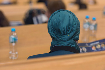 Muslim Business woman at business conference room with public giving presentations. Audience at the conference hall. Entrepreneurship club.