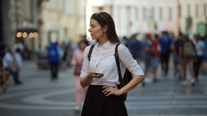 Girl on the street among the crowd of passers-by, photos in the style of surveillance