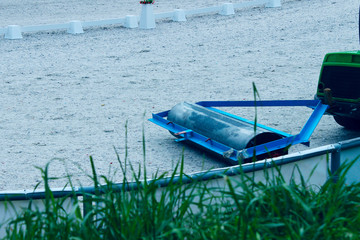 The machine aligns the sand in the exit arena. Preparing the arena for dressage. Dressage, Equestrian, Preparation concept. 