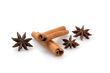 Cinnamon sticks and star anise stars on a white background.