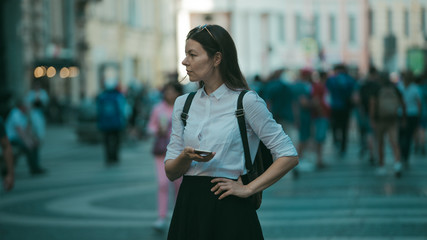 Girl on the street among the crowd of passers-by, photos in the style of surveillance