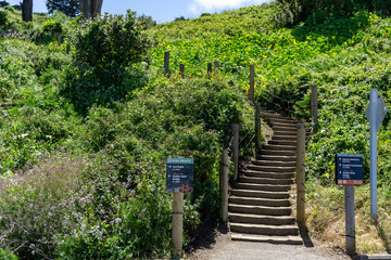 Sign next to path leading to greener hills