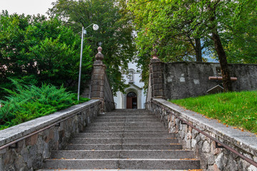 Fototapeta na wymiar Entrance Steps to Main Church, Župnijska cerkev sv. Urha in Bovec, Flitsch, Slovenia, Europe.