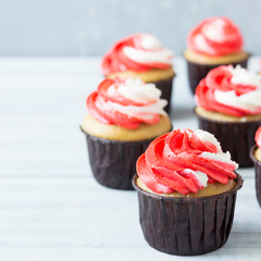 Delicious cupcakes with red and white cream for the holiday.
