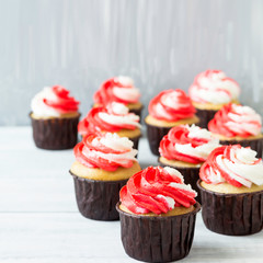Delicious cupcakes with red and white cream for the holiday.