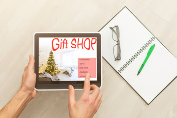 Man shopping christmas gifts with a laptop through internet