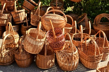 Lots of yellow wicker baskets piled up.Yellow texture, background.