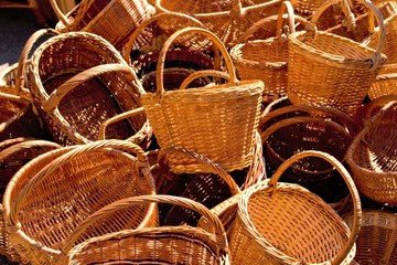 Lots of yellow wicker baskets piled up.Yellow texture, background.