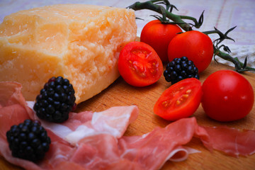 Italian food, prosciutto, olives, cheese and tomatoes