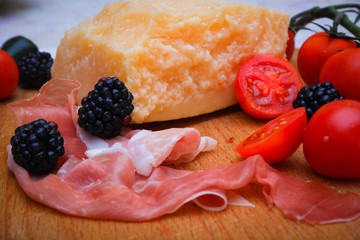 Italian food, prosciutto, olives, cheese and tomatoes