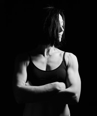 Obraz premium portrait of a beautiful athletic girl with black hair, her arms crossed