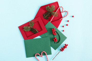 Christmas holiday composition. Xmas decorations, fir branches, red and green envelope, red berries...