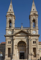 Fototapeta na wymiar ALBEROBELLO, ITALY - AUGUST 28 2017: Day view of the cathedral of saints Cosmas and Damian in Alberobello, south of Italy