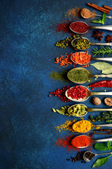 Assortment of natural spices on a vintage spoons.Top view with copy space.