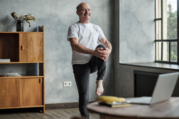 Senior hispanic man standing in one leg yoga balance. Healthy lifestyle at old age
