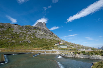 Norway landscape with red fishing house and deep blue sky.
