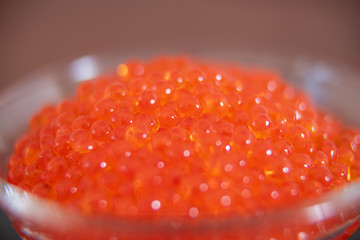 Red caviar in the glass jar close up macro