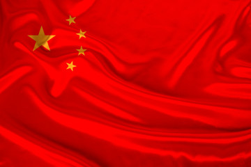 photo of the national flag of China on a luxurious texture of satin, silk with waves, folds and highlights, closeup, copy space, concept of travel, economy and state policy, illustration