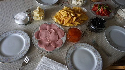 breakfast time, breakfast table french fries, jam, butter, cheese, tea, olives, bread etc ...