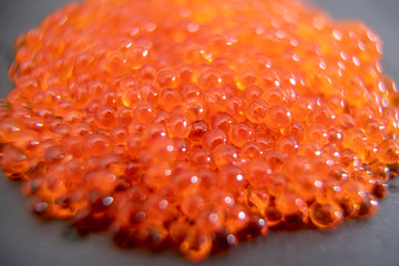 Red caviar close up on the grey stone background
