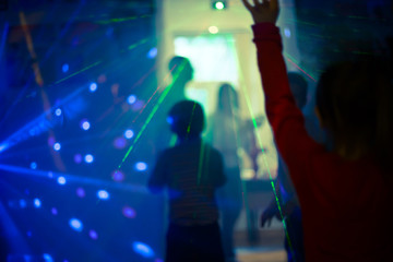A child in the laser beams. Laser show at the children's disco. Party for children for New Year and...