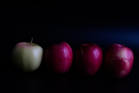Red apples on a black background