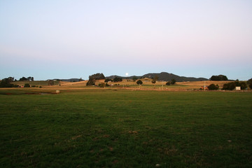 Fototapeta premium Moon-rise over the town of Sheffield in Tasmania. Australia.