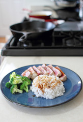 Ahi tuna sliced thin with teriyaki demi-glace, served with rice and broccoli.