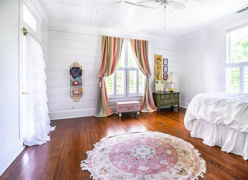 Bedroom With Shiplap Walls, Rug, Ruffles, Pastels, Wood Floors