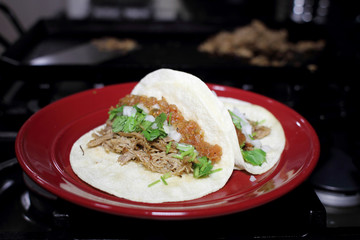 Delicious pulled pork tacos known as 