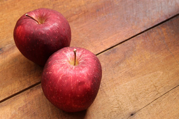 Red apple fruit on brown wooden background