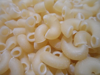 raw pasta background on the table, in one layer.