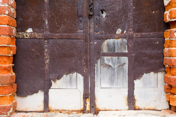 blocked entrance to an abandoned antique building with crumbling walls. Close-up © Вячеслав Думчев