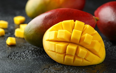 Fresh Mango Tropical fruit on rustic black background