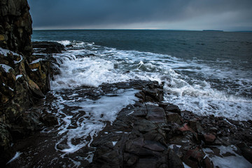 Waves breaking over rocks.