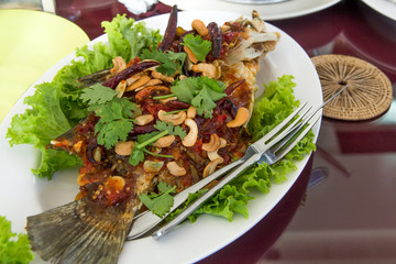 Fried fish topped with sweet and sour sauce on dish,Thai food,Selective focus