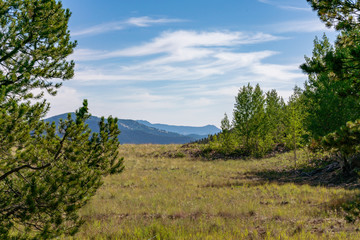 A beautiful view of mountains in the distance from a restored mining site. 