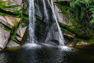 Close up view of a waterfall in the forest during summer season in La Cumbrecita, Córdoba, Argentina